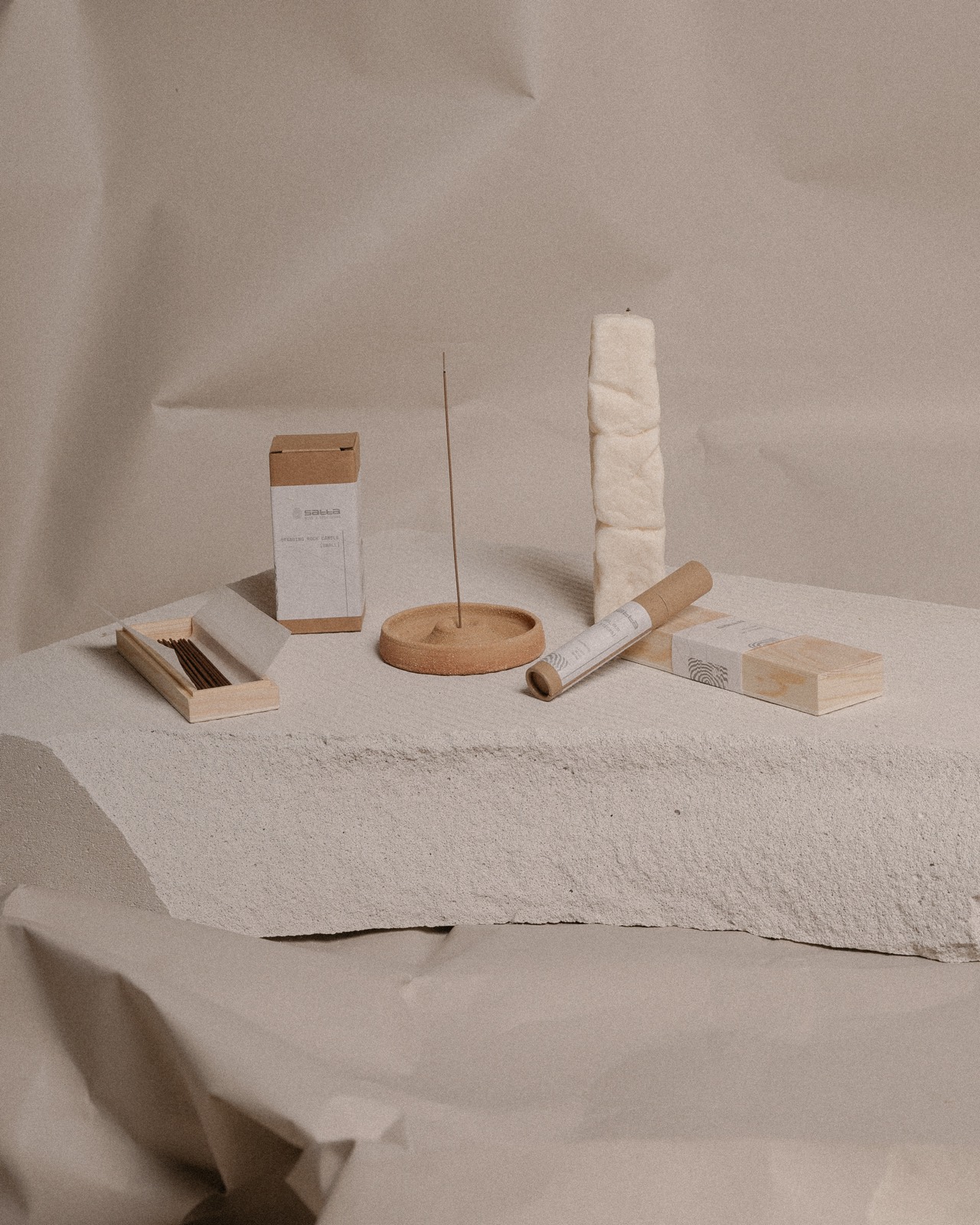 Satta incense and holder on a plaster plinth