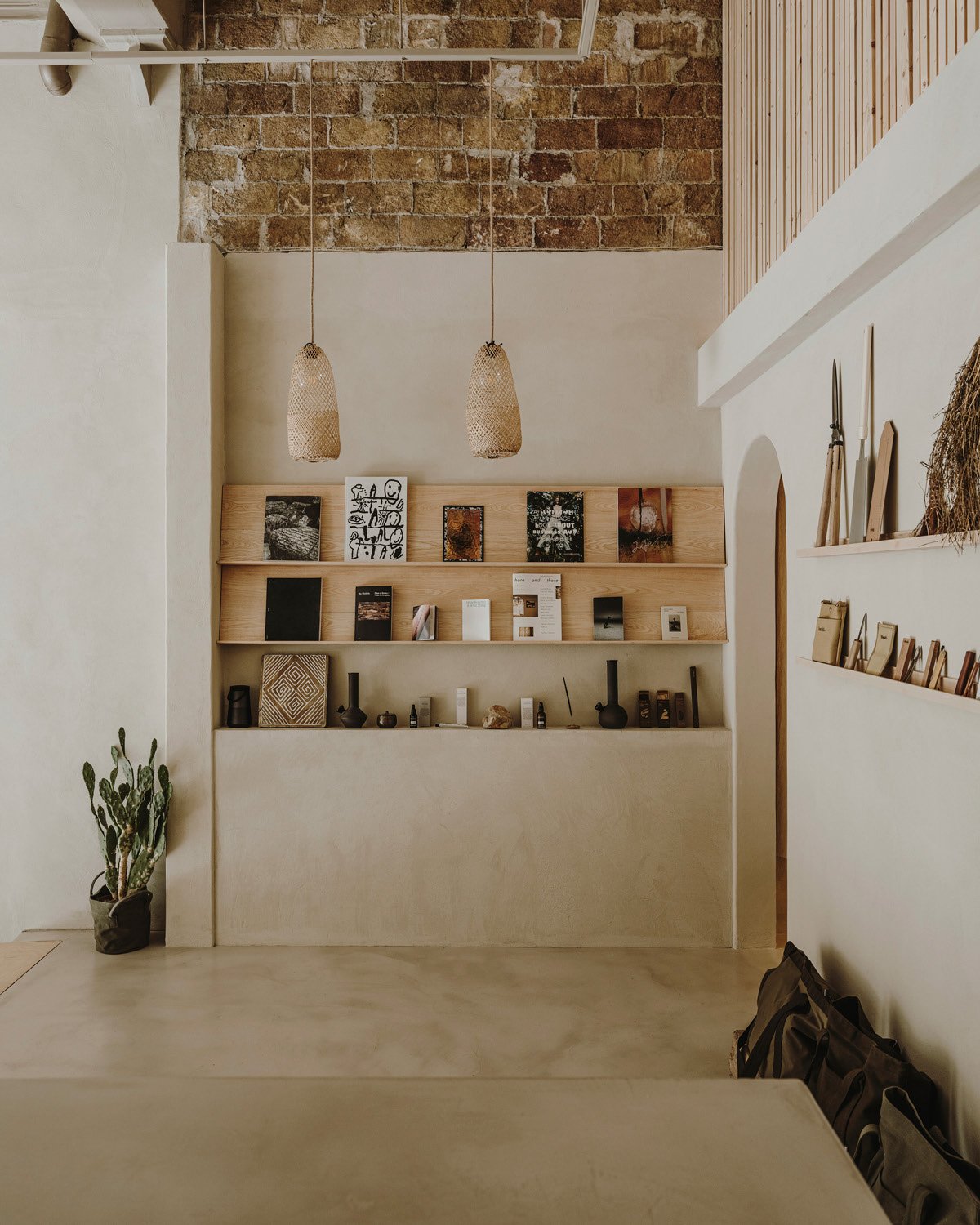 Timber shelving against exposed brick