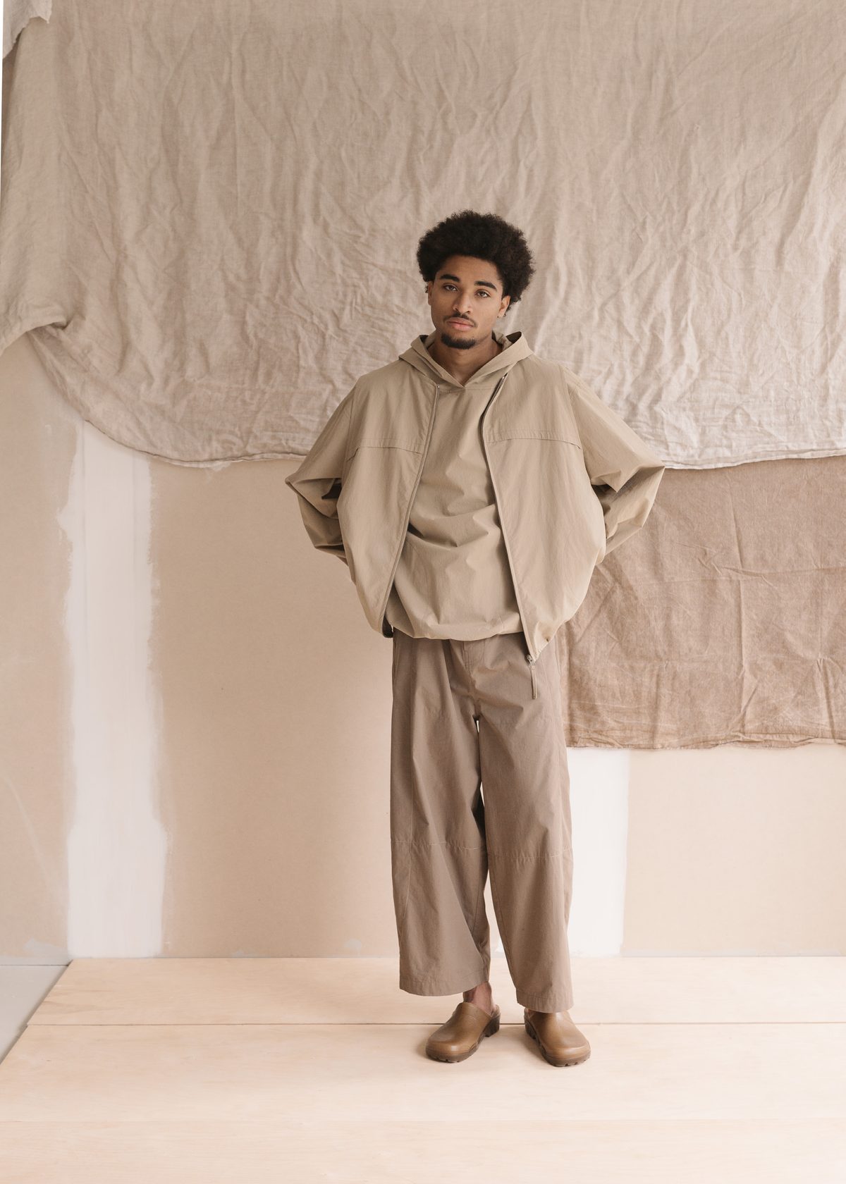 Satta SS25: hooded cape jacket over wide trousers
