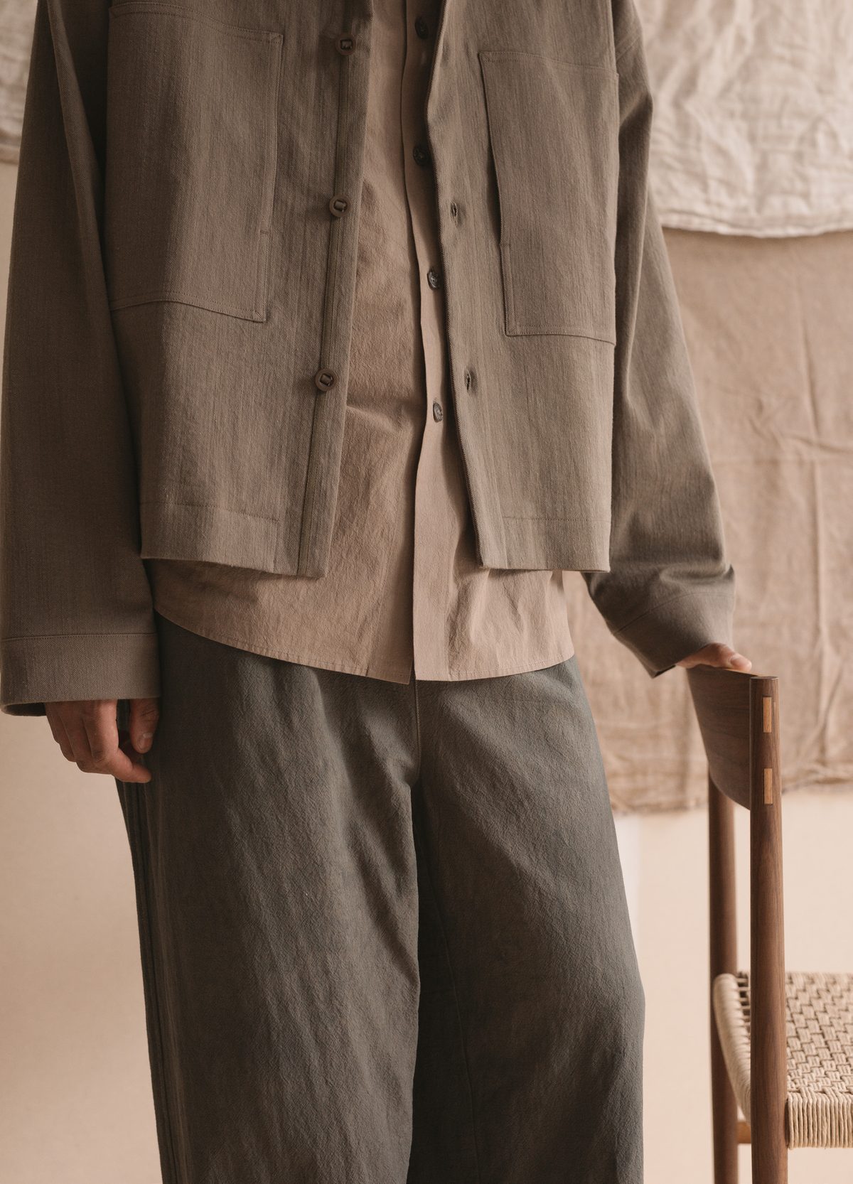 Satta SS25: pocket and hem detail of a washed overshirt