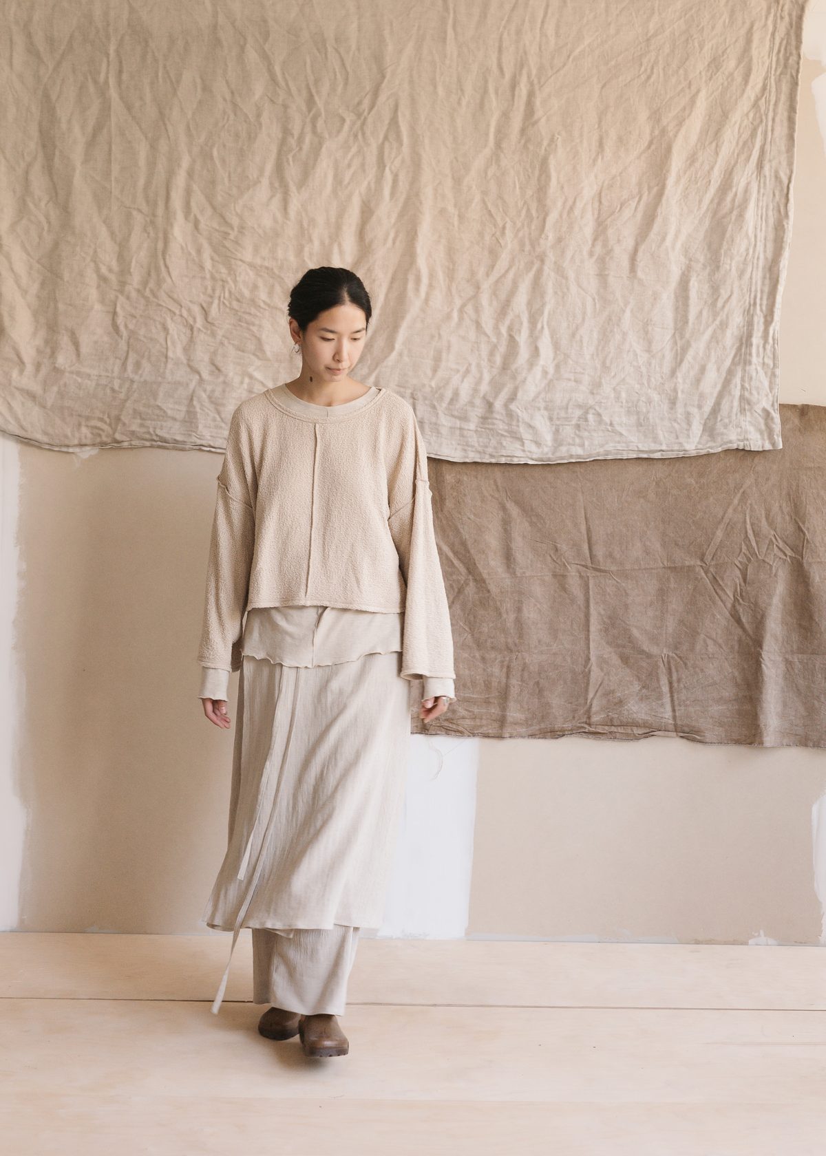 Textured knit layered over a long skirt and trousers