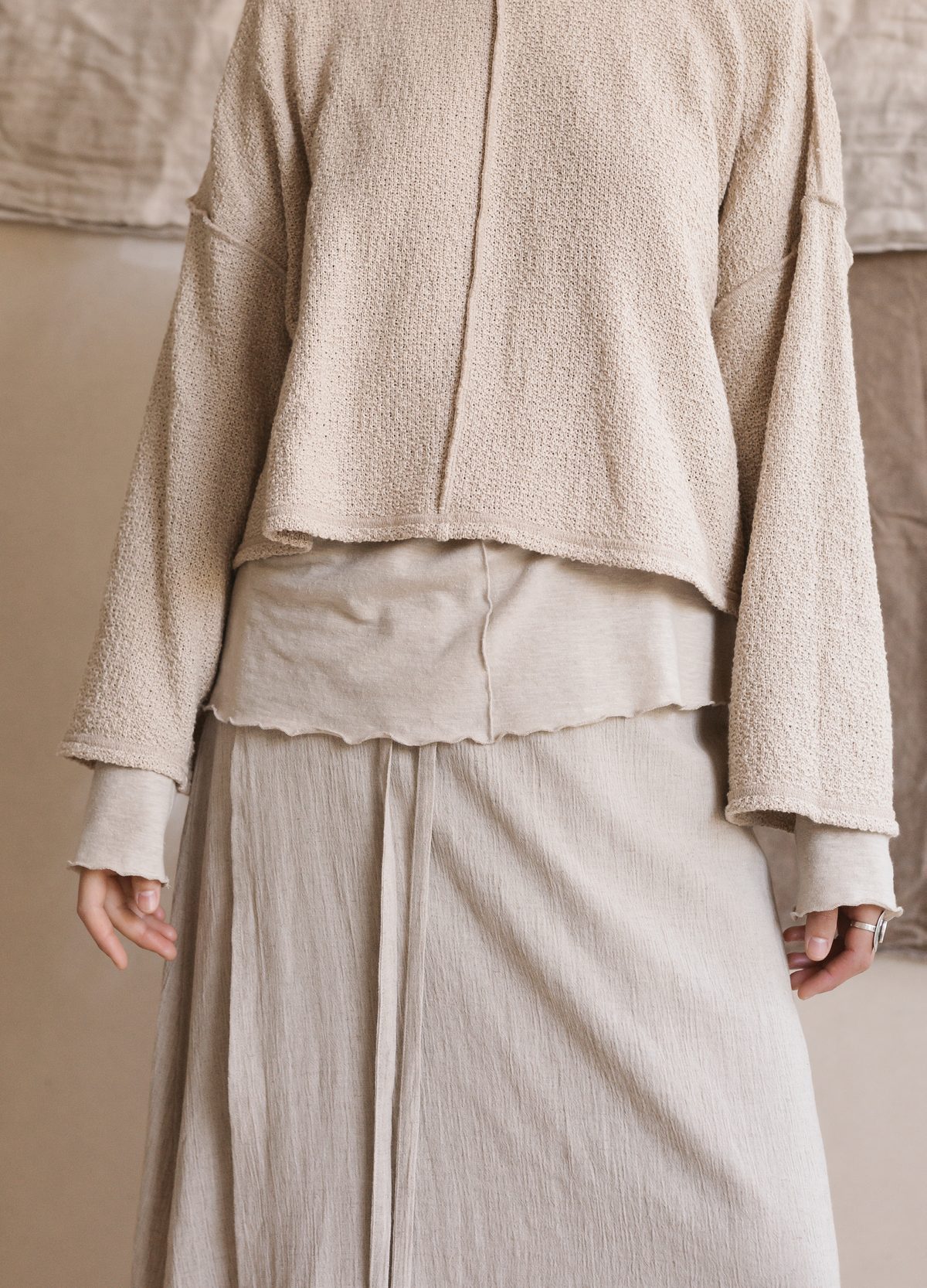 Detail of a textured knit over a layered skirt