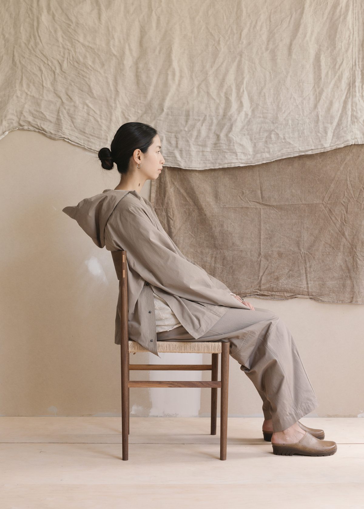 Hooded top and trousers, seated side-on